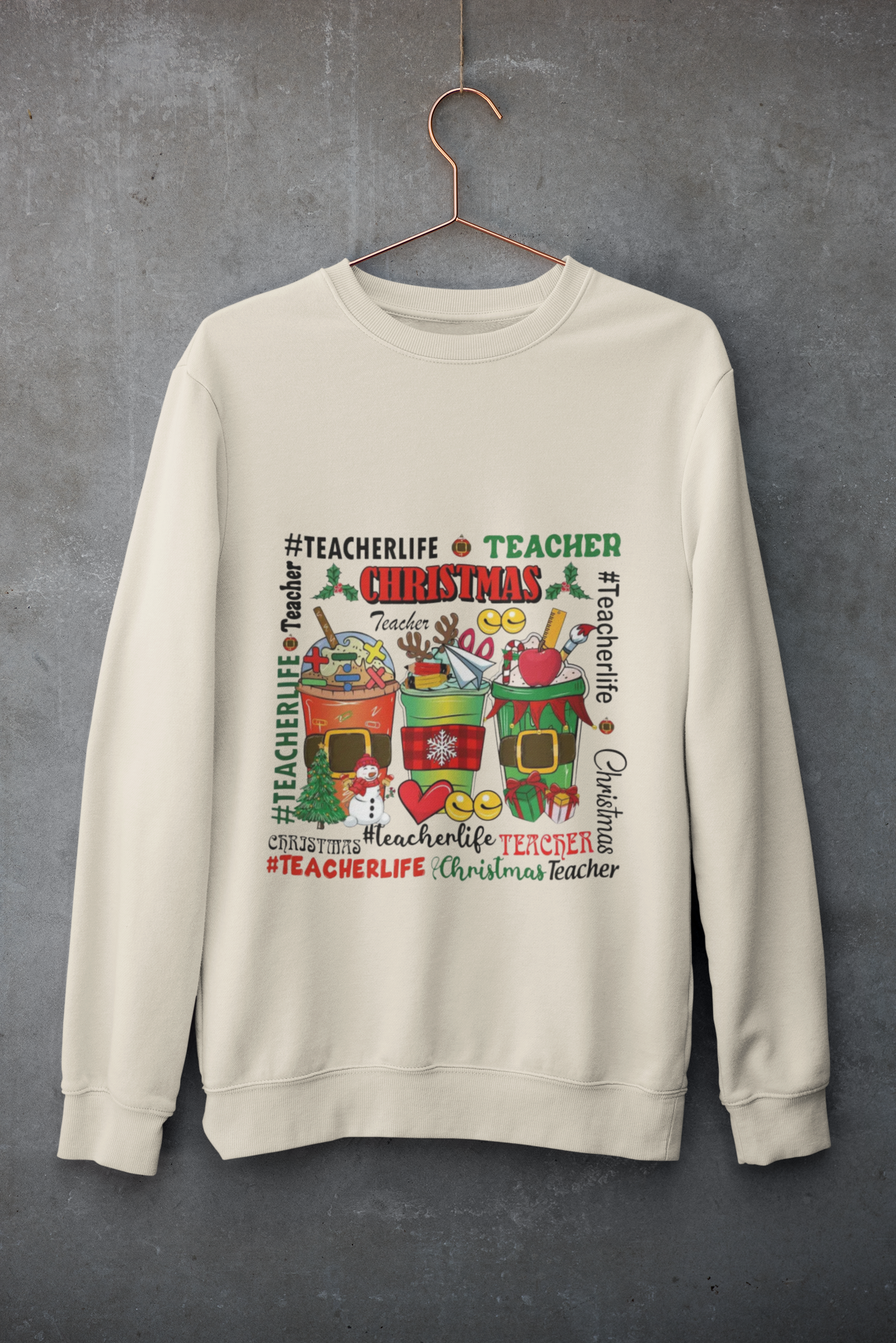 Beige sweatshirt with Christmas-themed graphics and text on a gray background